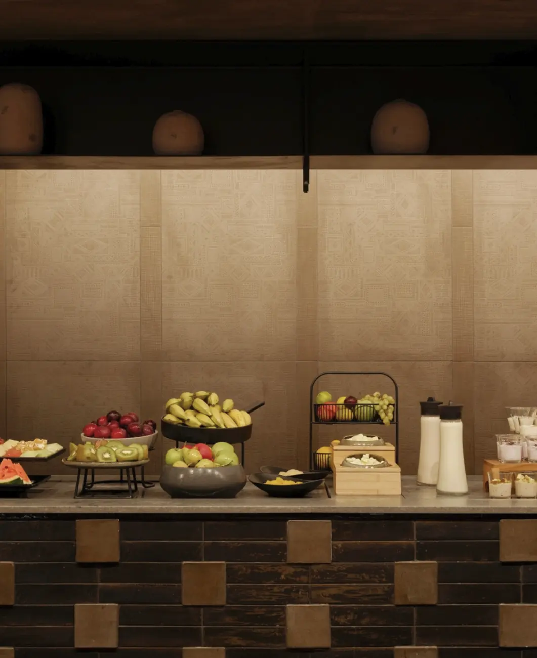 Fruit and dairy station in front of a backlit textured wall